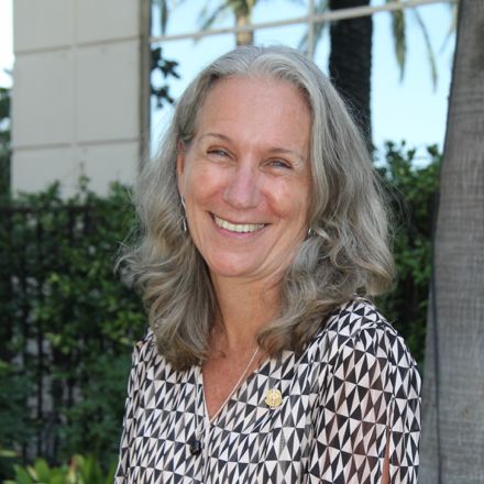 Doreen Bartoldus standing in front of a building.